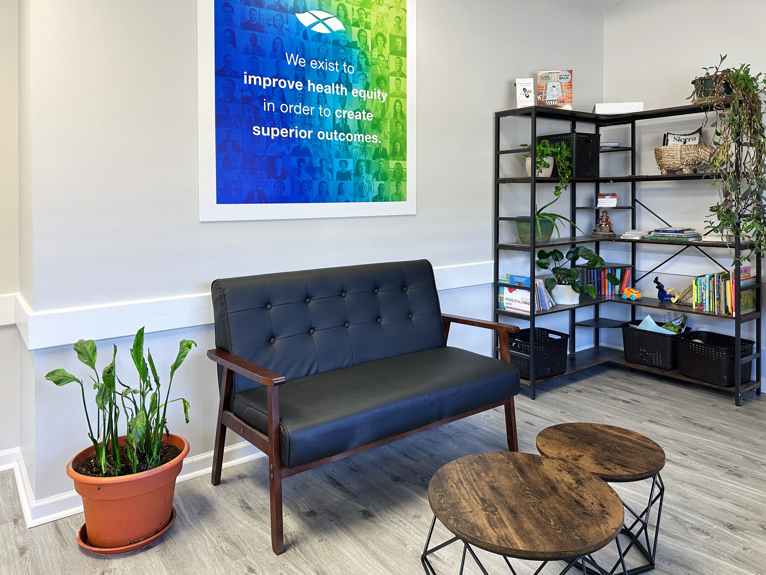 Lounge seating area with bookshelf and indoor plants