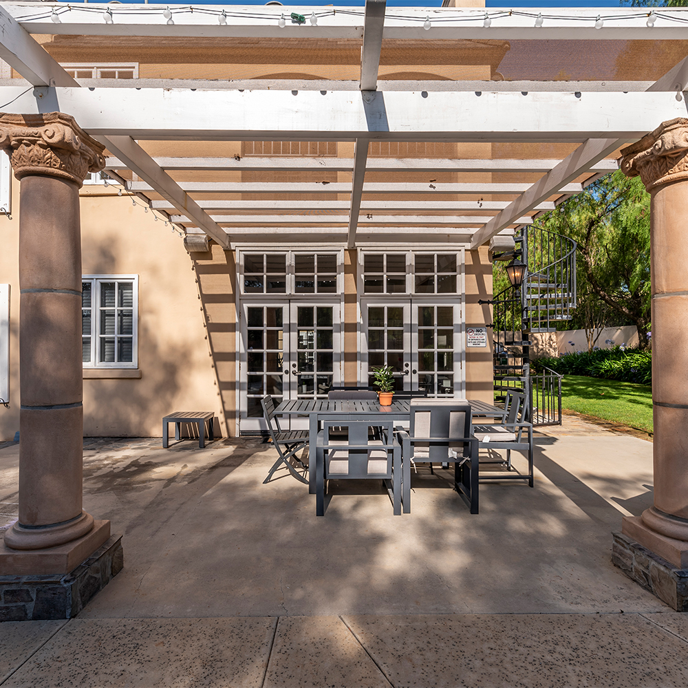 Outdoor patio with pergola and seating.