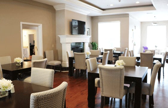 Elegant dining space with TV and natural light