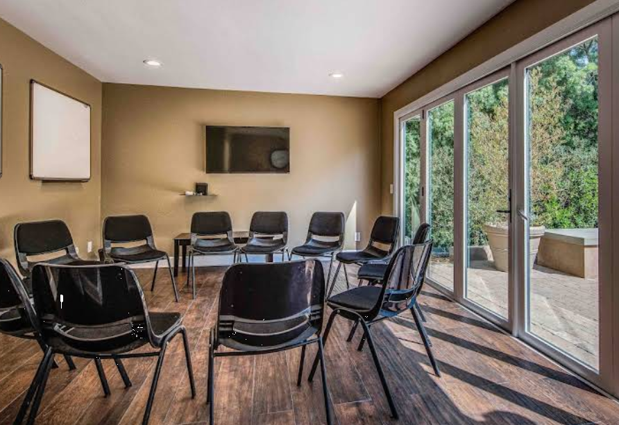 Circle of chairs in bright therapy meeting room