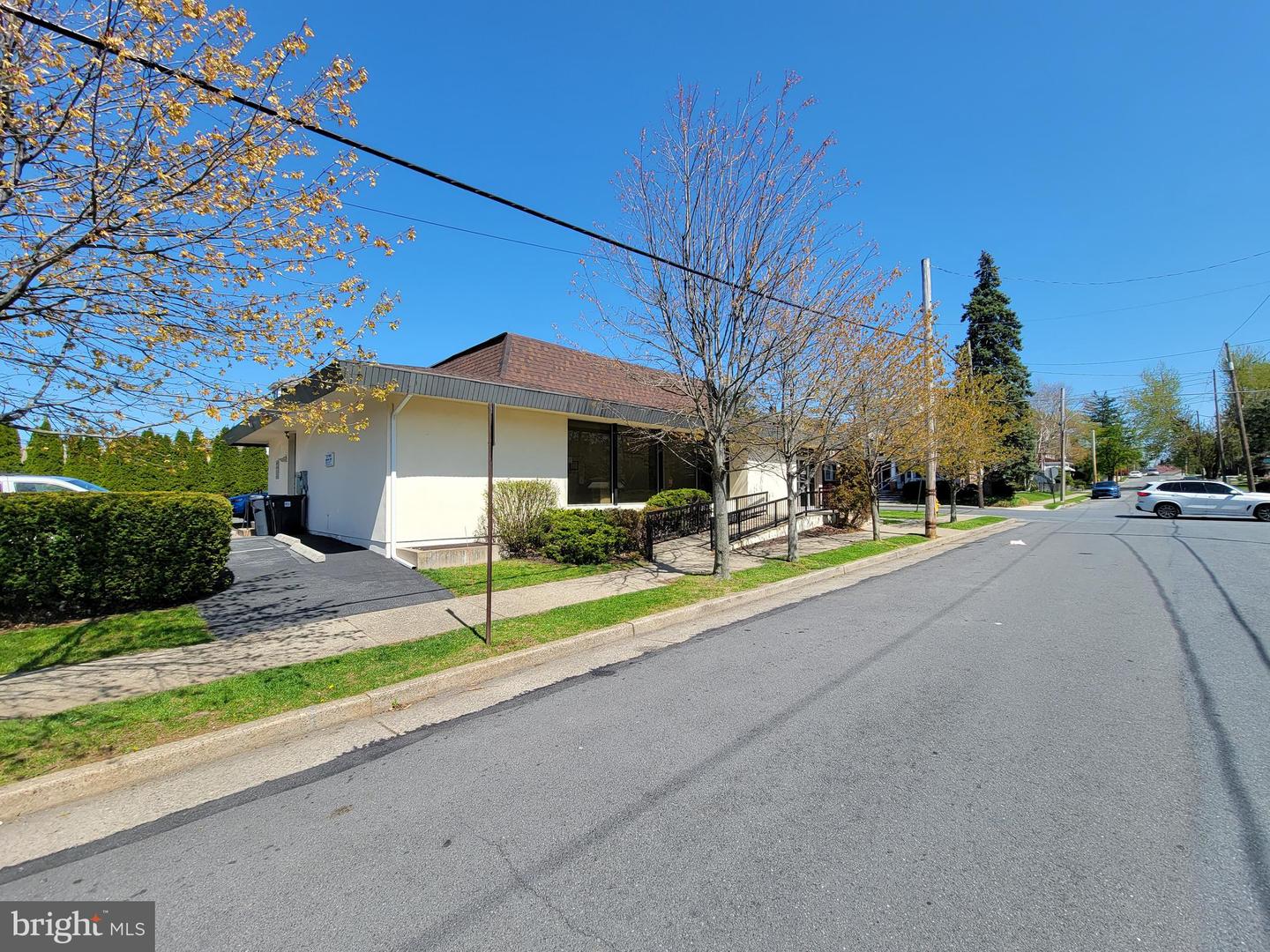 A bright, sunny view of the CleanSlate Medical Group building from across the street, showcasing its accessibility and location.
