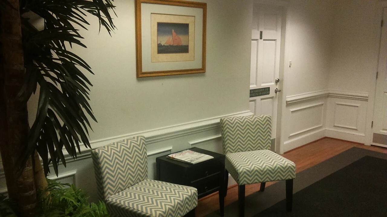 Two chairs with side table in a small waiting area
