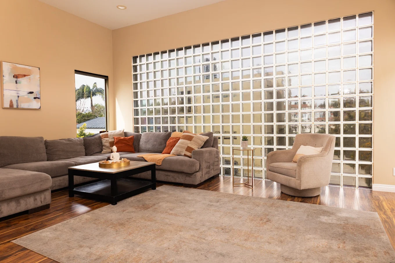 Modern lounge with gray sofa and glass block wall