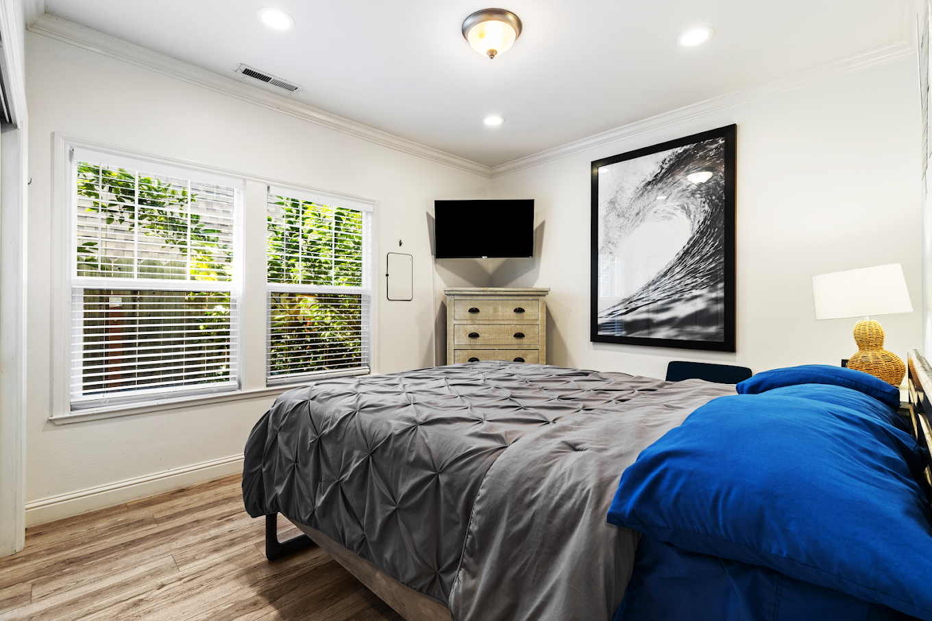 Queen bed with dresser and TV