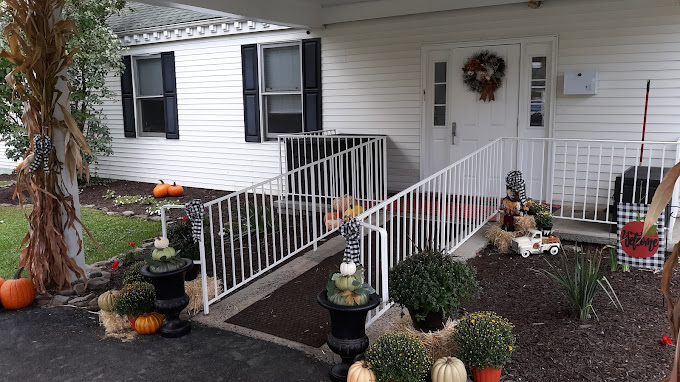 White ramp entrance with pumpkins and fall decor