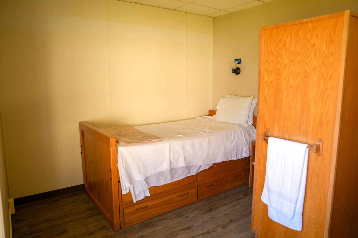 Shared bedroom with single bed, storage drawers, and closet