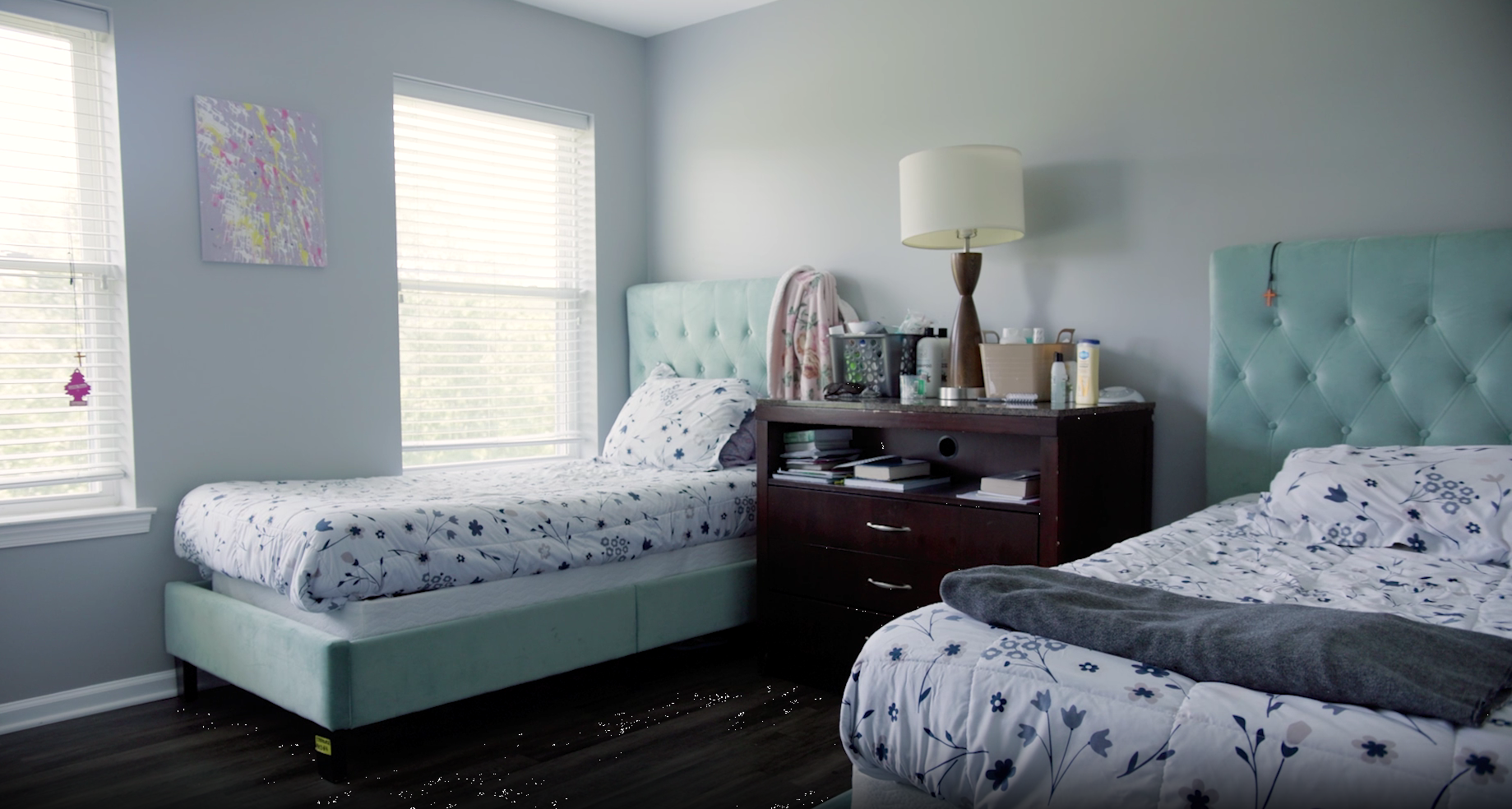 Shared bedroom with twin beds and nightstand in residential treatment