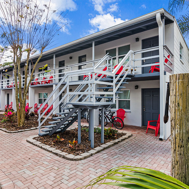 Facility exterior with two floors and stairs to entrance.