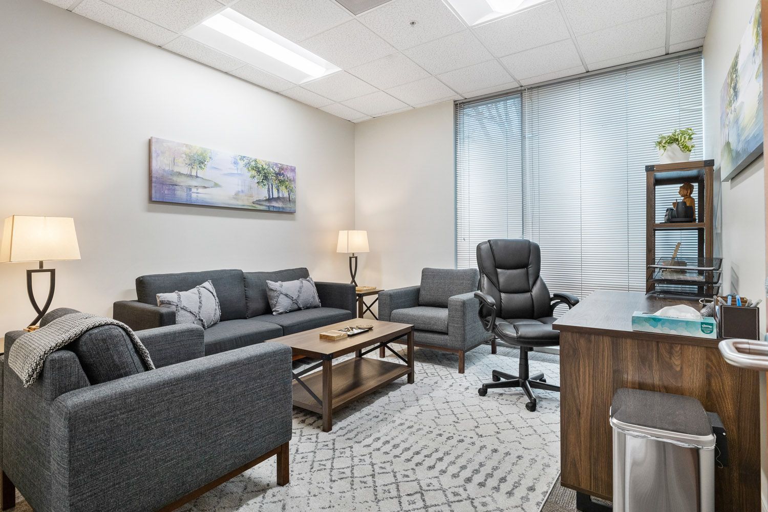 Counseling room with sofa, armchairs, and desk