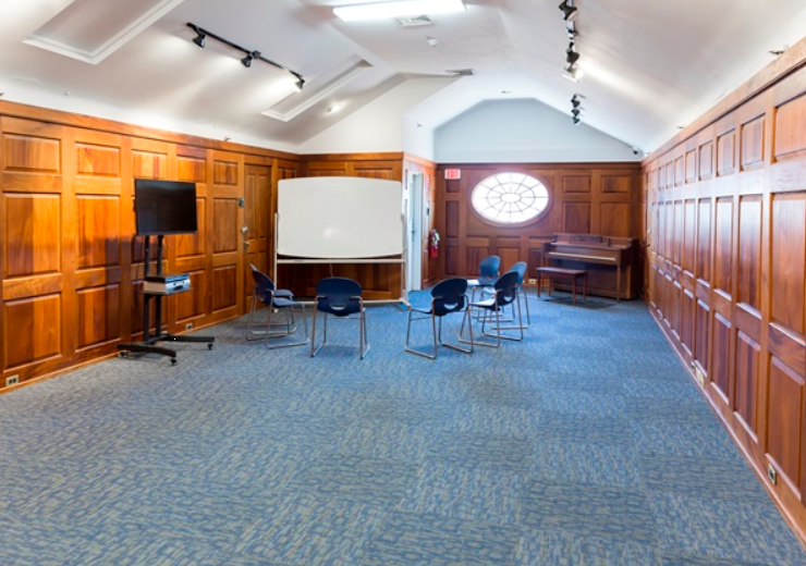 Meeting room with chairs, whiteboard, and TV