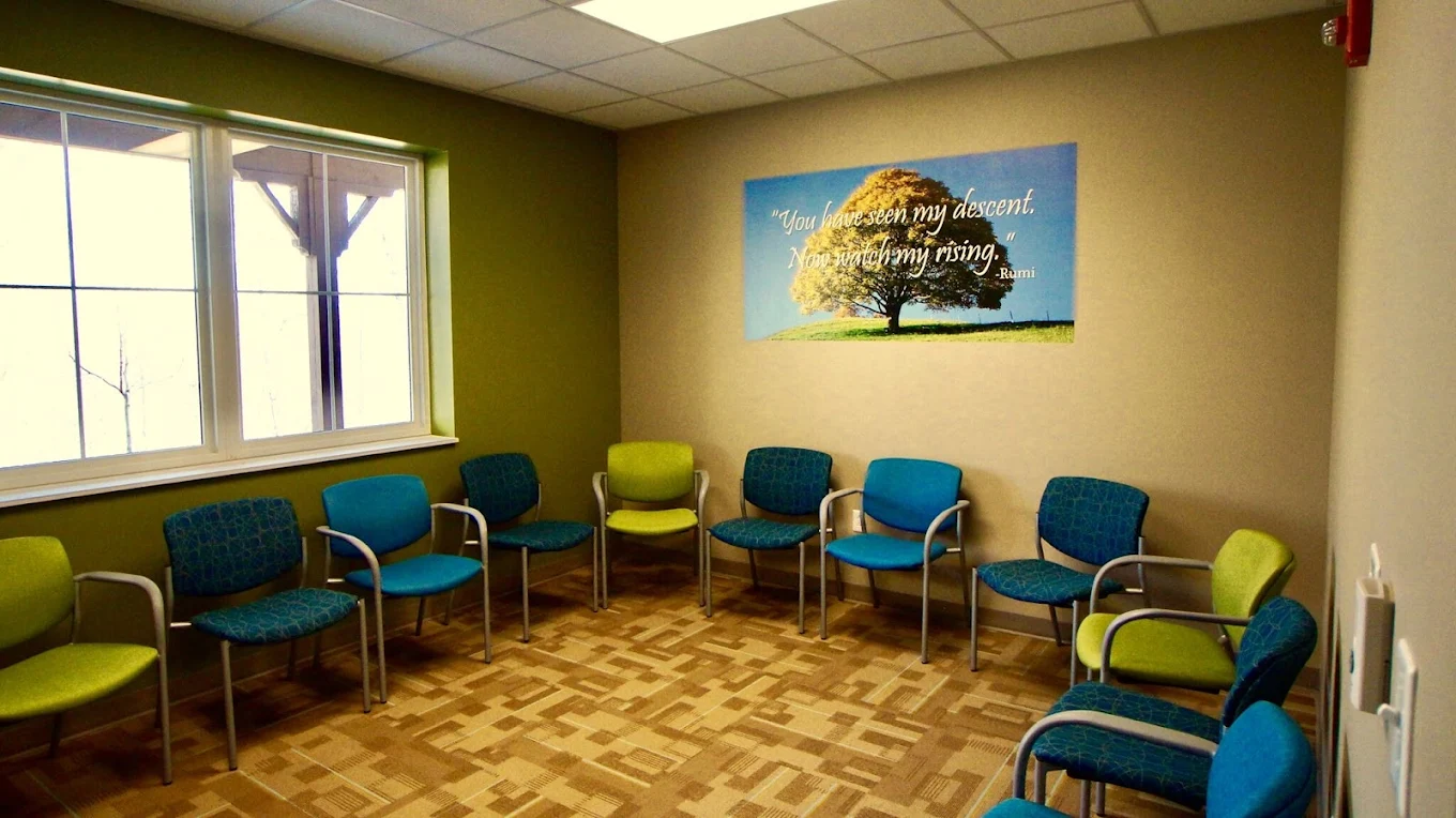 Bright therapy room with circular chairs and quote on the wall