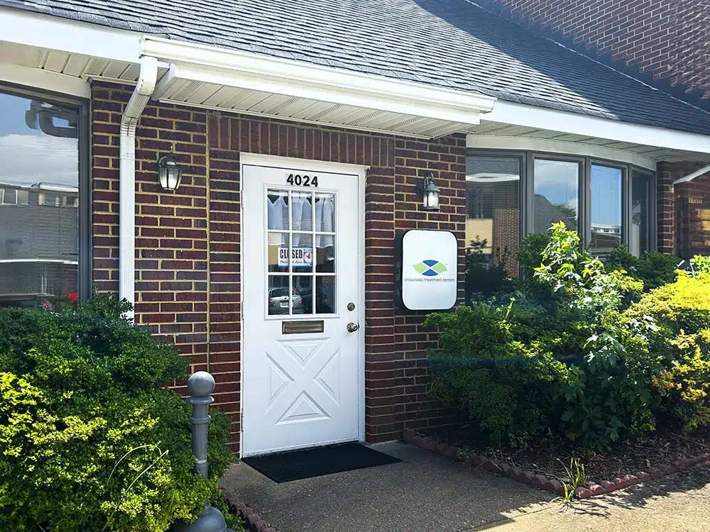 Brick building entrance with Crossroads Treatment Center sign