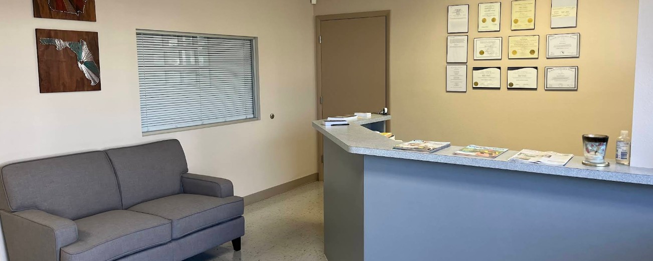 Reception area with front desk and waiting sofa