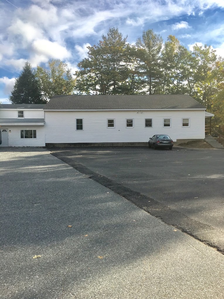 Facility exterior with parking and stairway to entrance.