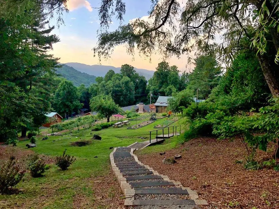 Walking path through wooded grounds with mountain views