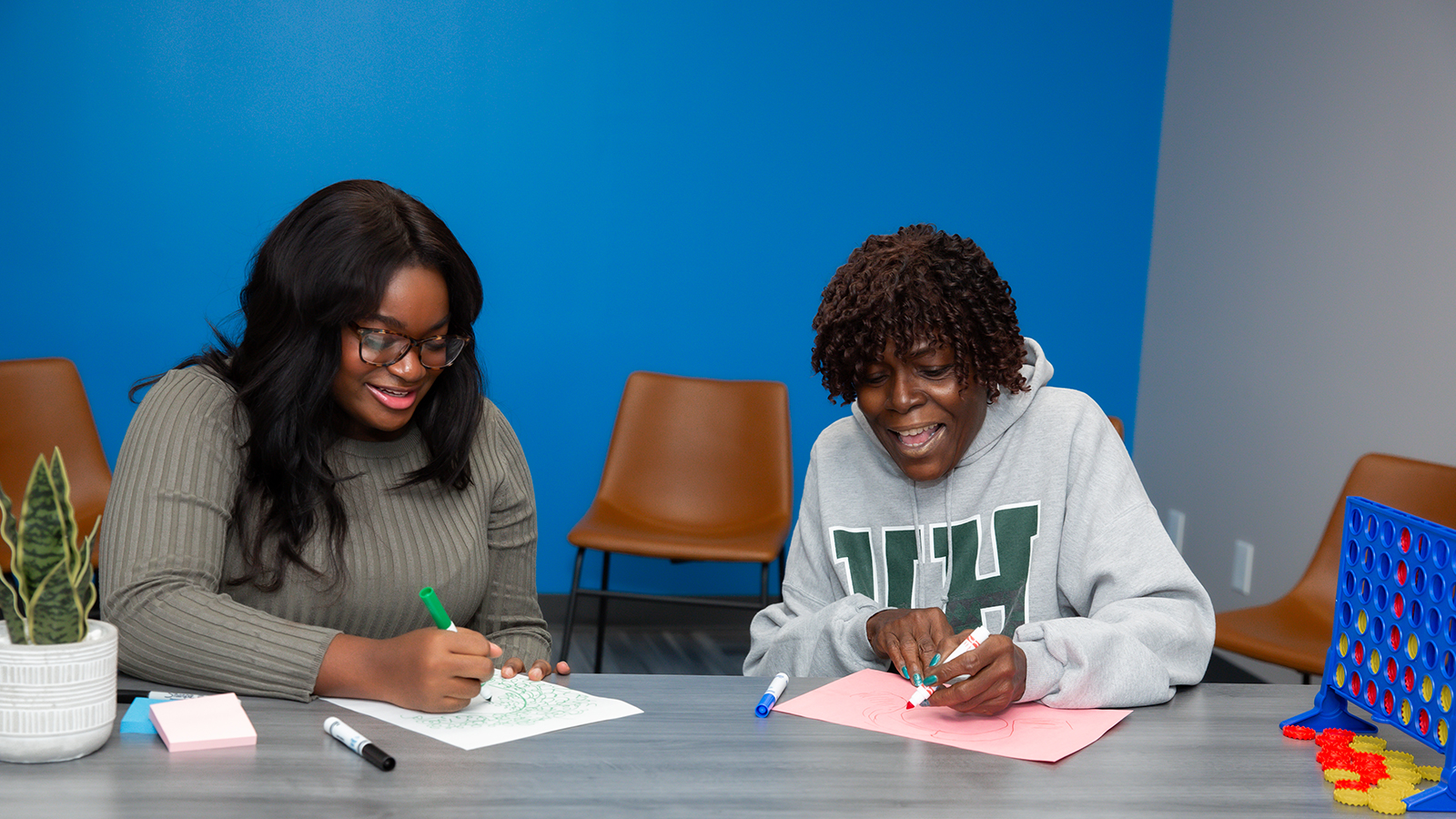 Therapy room with a center table and chairs arranged around.
