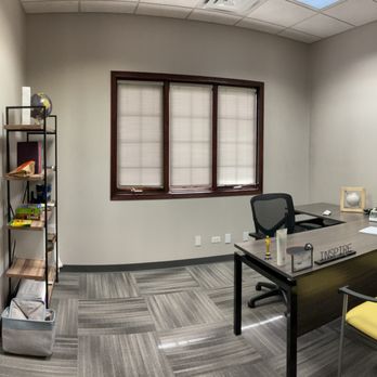 Private counseling office with desk and shelf décor
