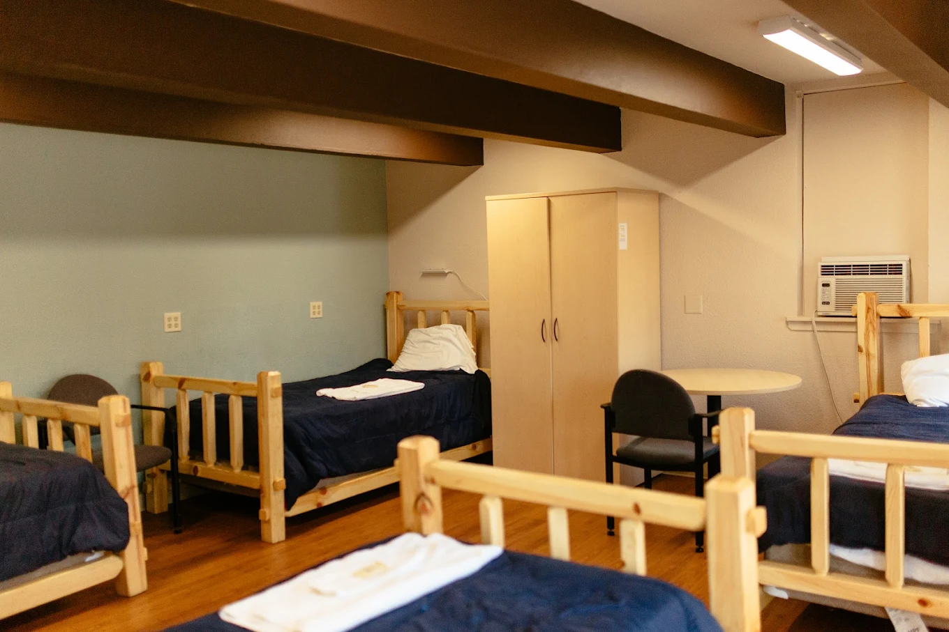 Shared bedroom with multiple beds and seating area
