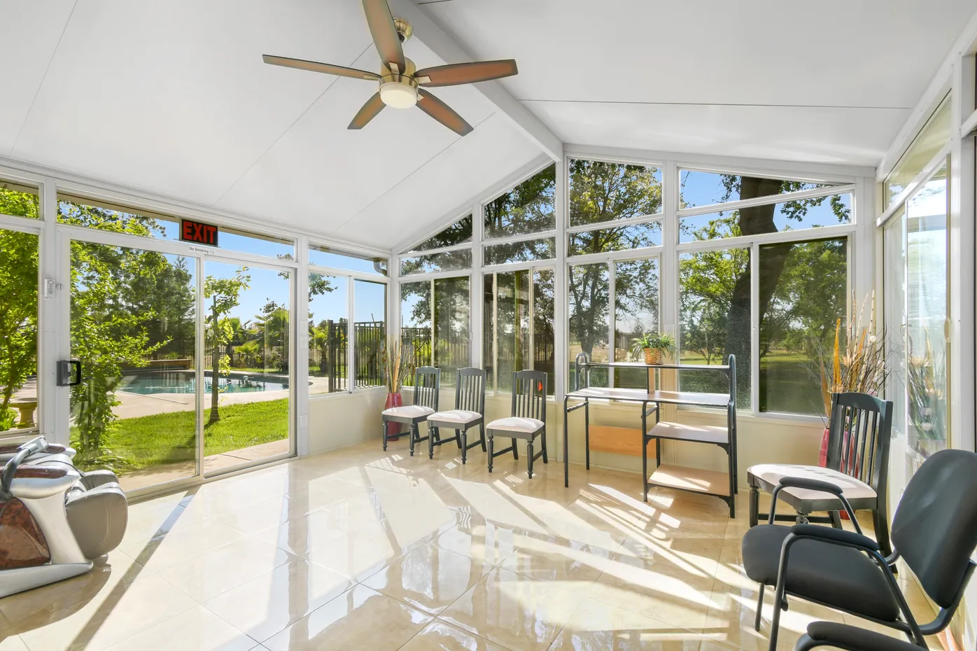 Bright room with chairs and view of outdoor pool
