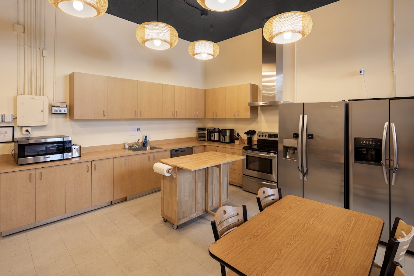 Large kitchen and dining area with modern lighting.