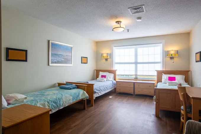Shared bedroom with two twin beds and large window