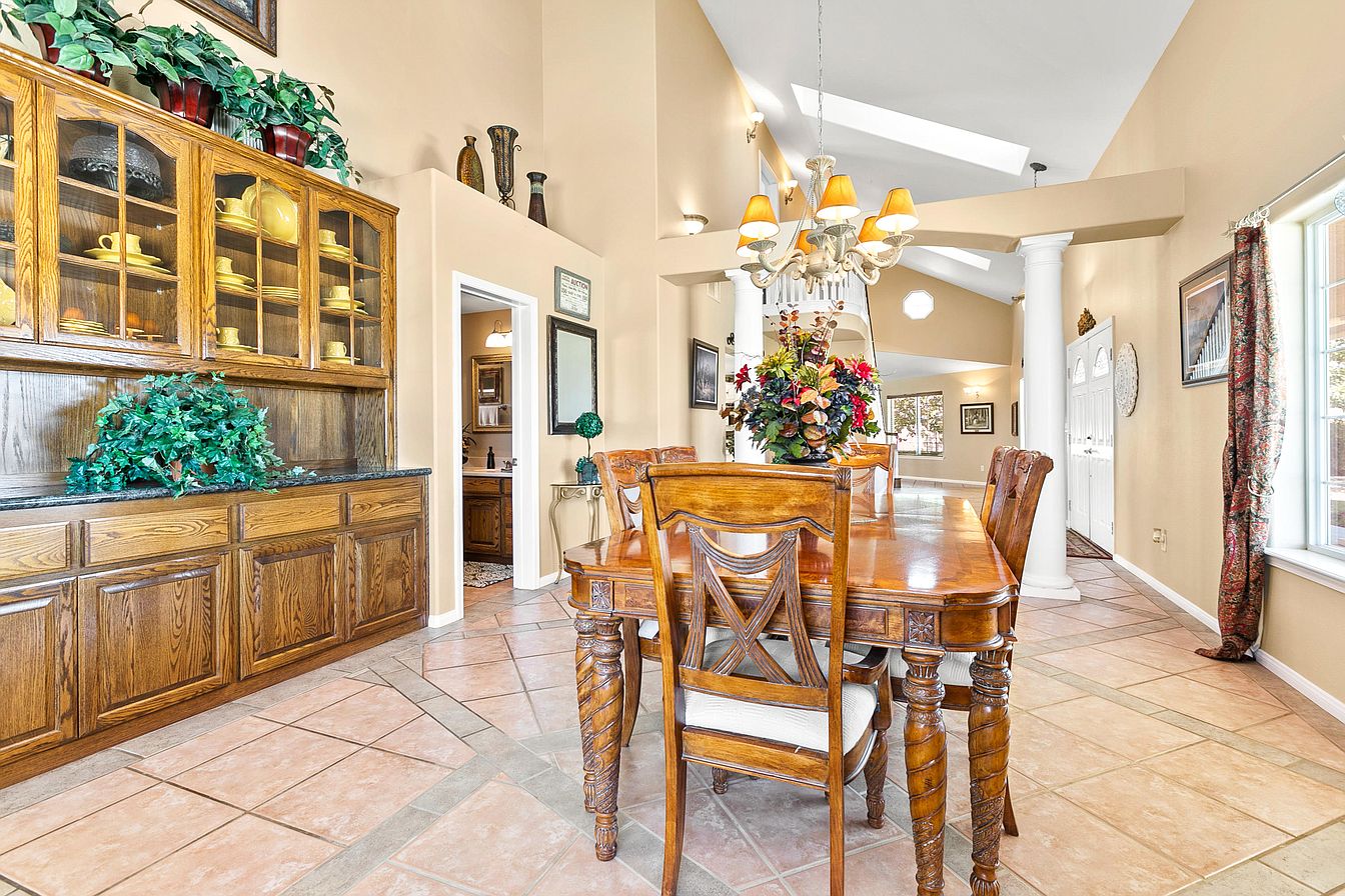 Bright dining area with chandelier and wooden furniture
