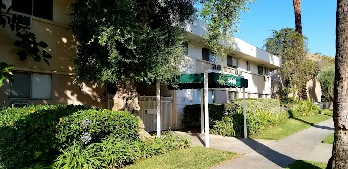 Front exterior of rehab center with greenery and walkway.