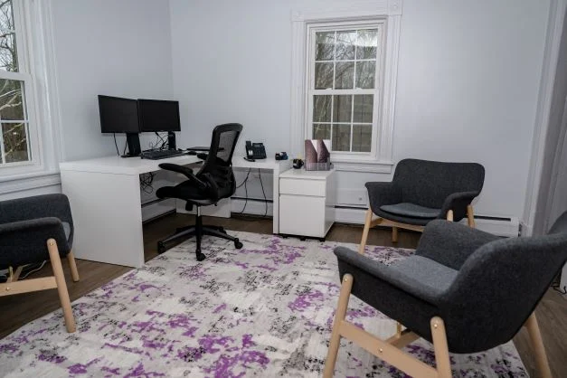  Therapy office with desk, computer, and chairs
