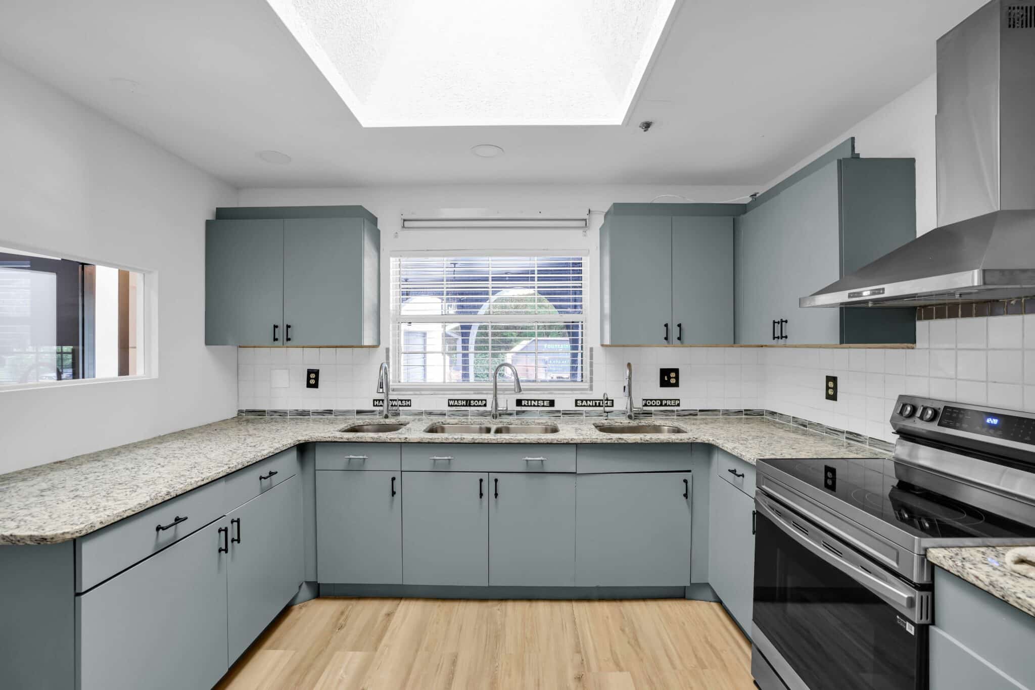 Commercial kitchen with multiple sinks and prep counters