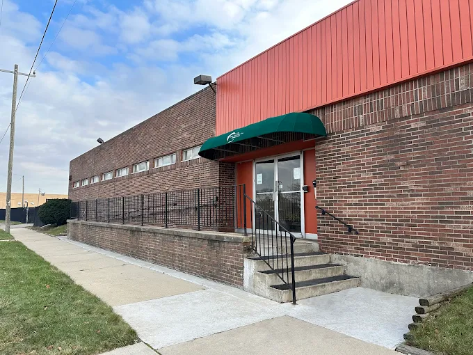 Brick building exterior with green awning entrance