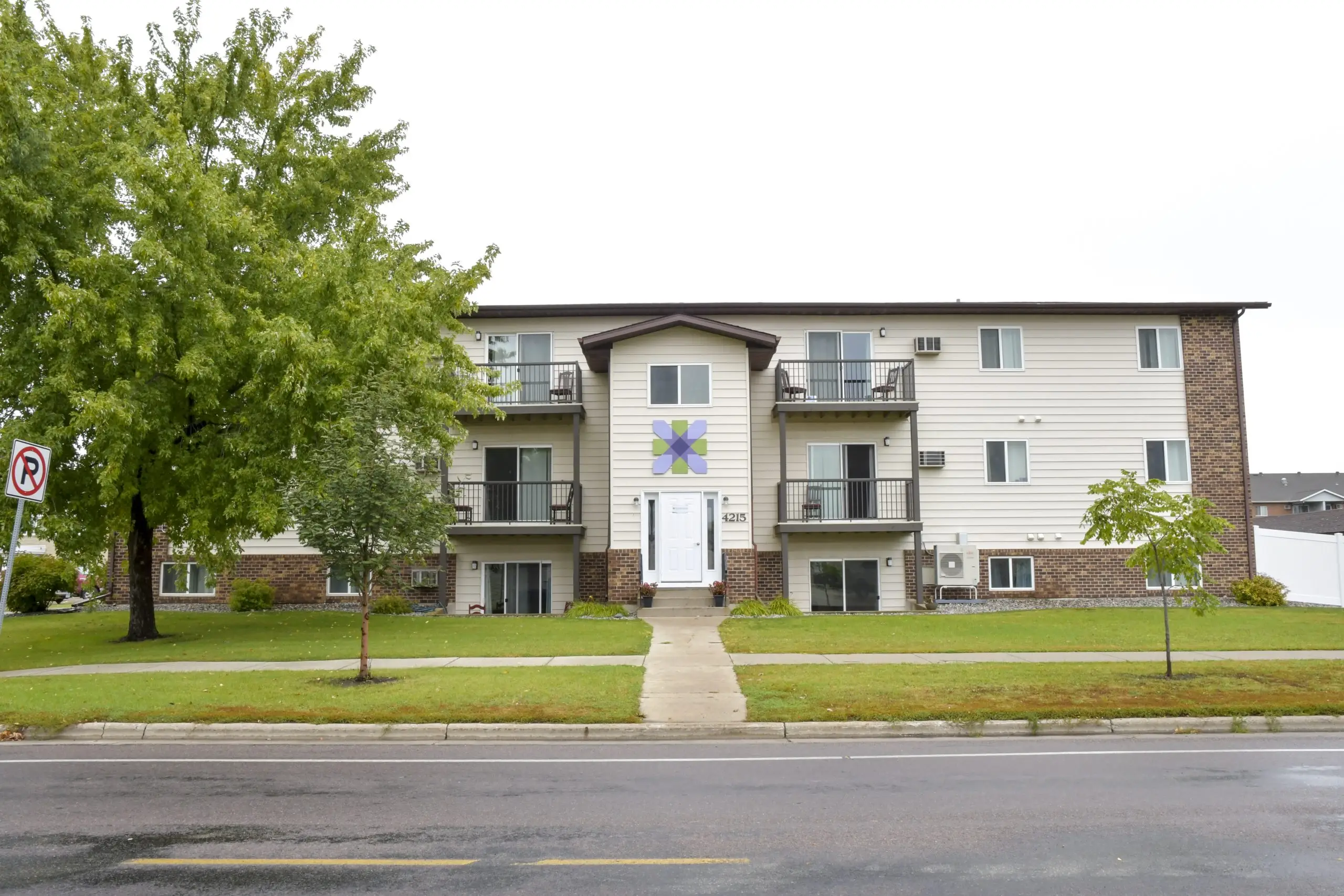 Three-story rehab housing with balconies and green lawn