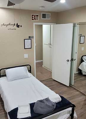 Simple bedroom with single bed and white walls