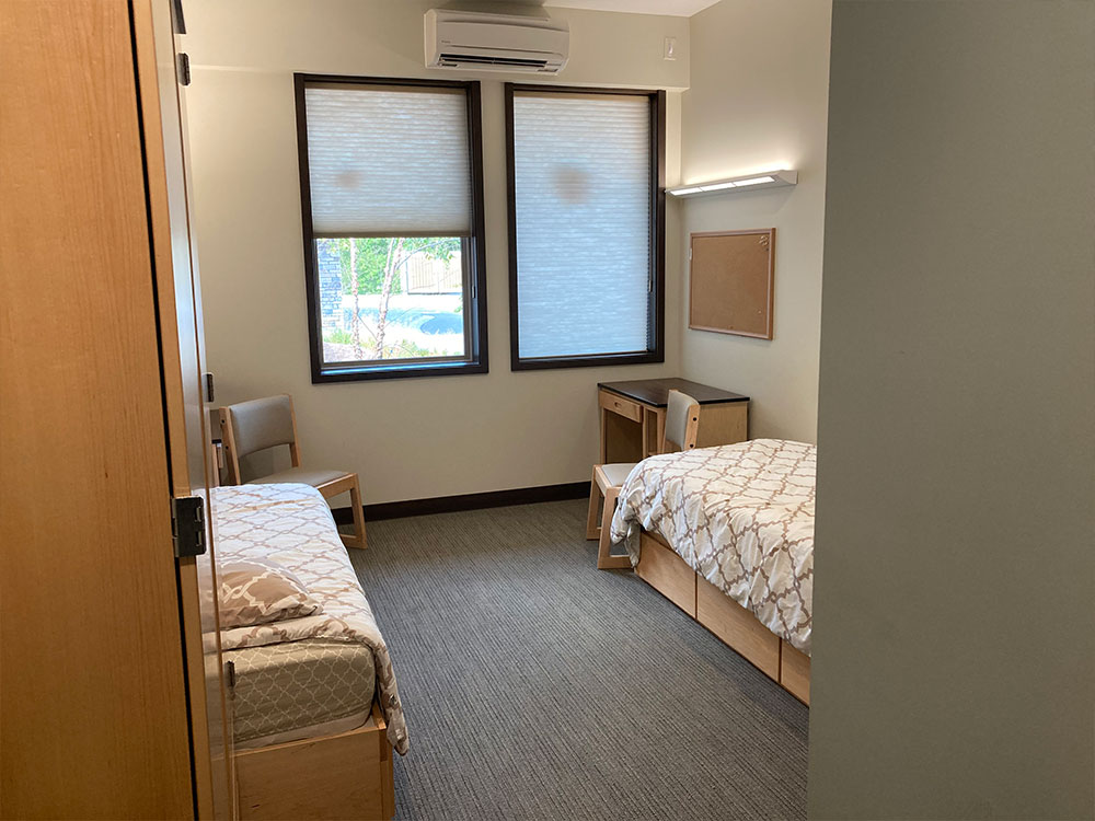 Simple shared bedroom with two twin beds and desks