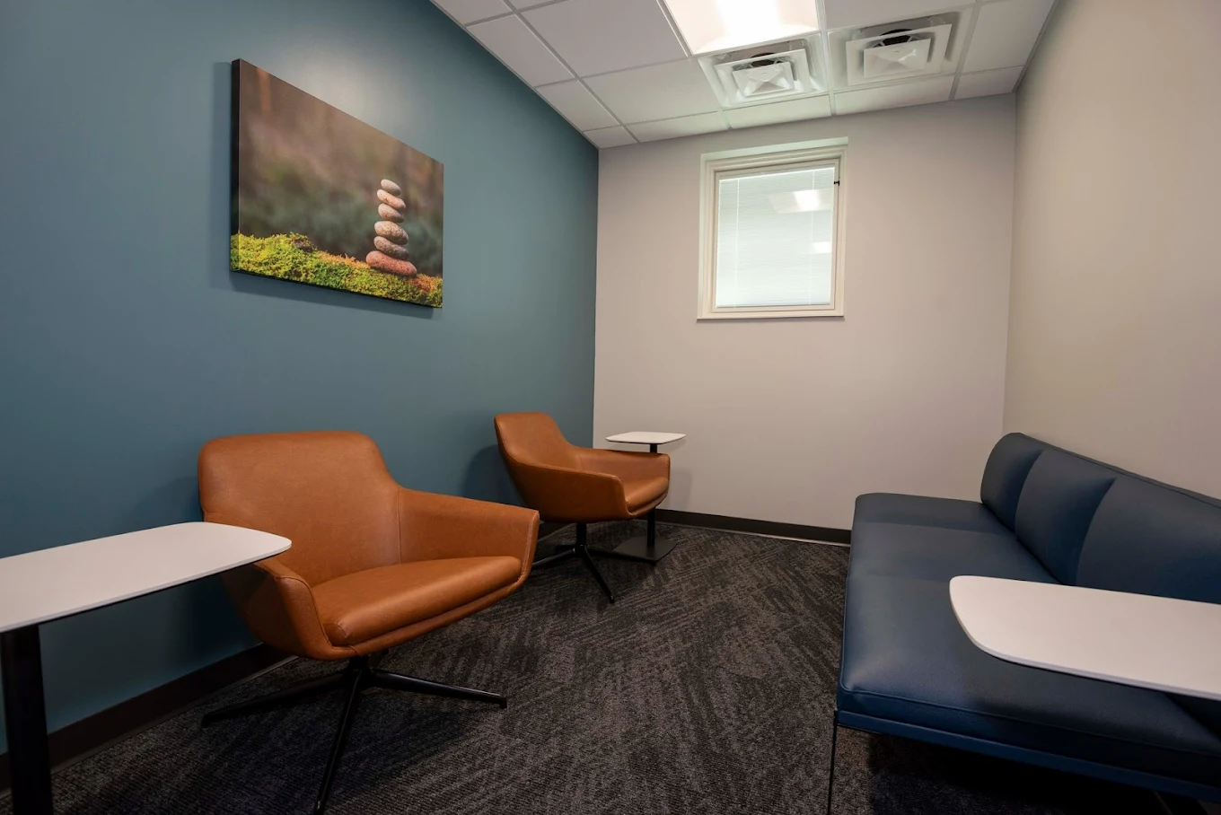 Private consultation room with chairs and calming wall art