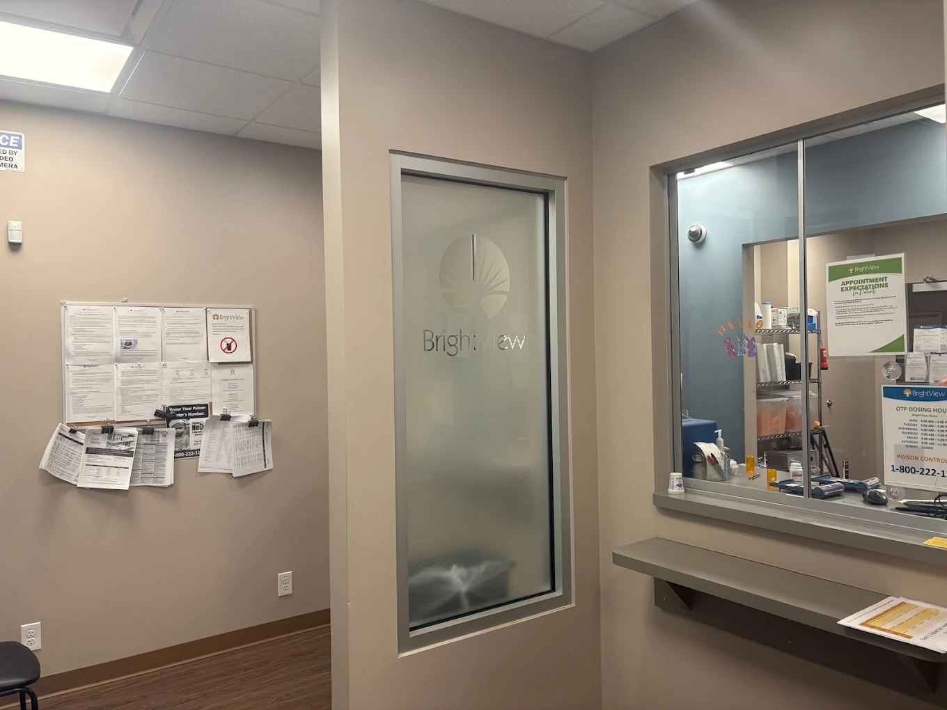 BrightView Akron medication dispensing area with service window, privacy glass, informational notices, and counter