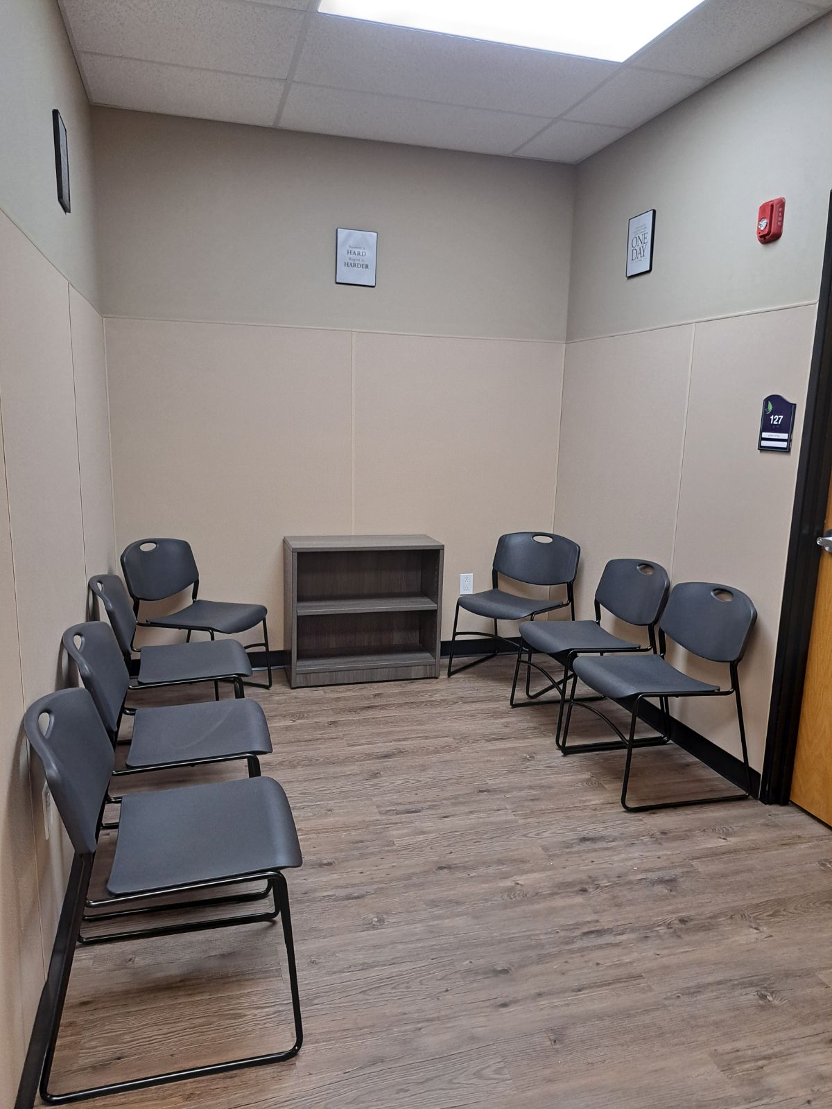 Small waiting area with chairs and shelving.