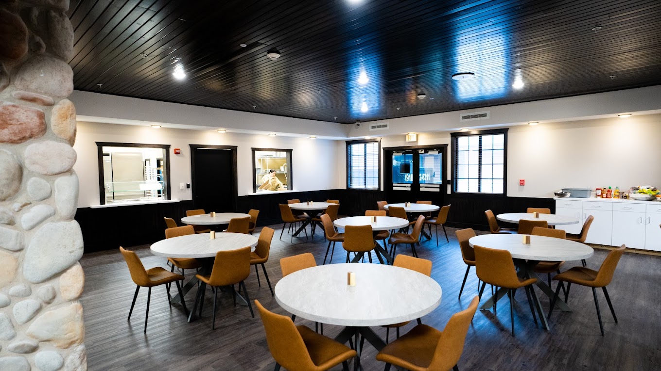Rehab dining area with modern decor and round tables.