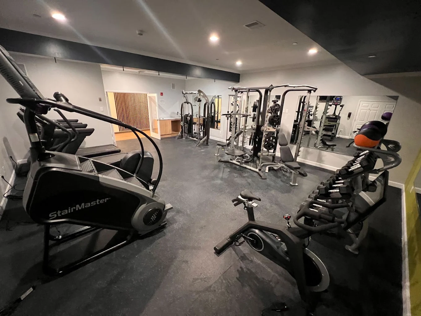 Gym with cardio and weight machines for client workouts