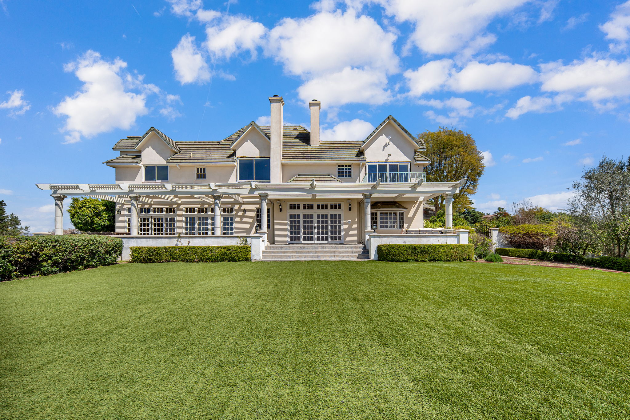 Wide lawn leading up to expansive home exterior