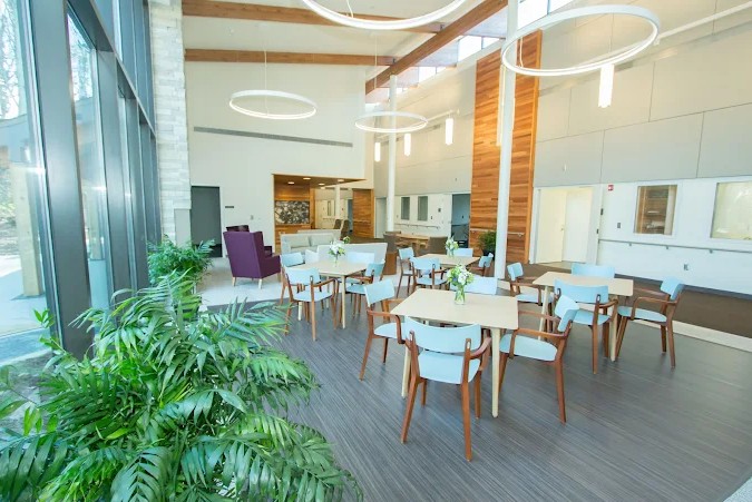 Bright dining space with tables and large windows