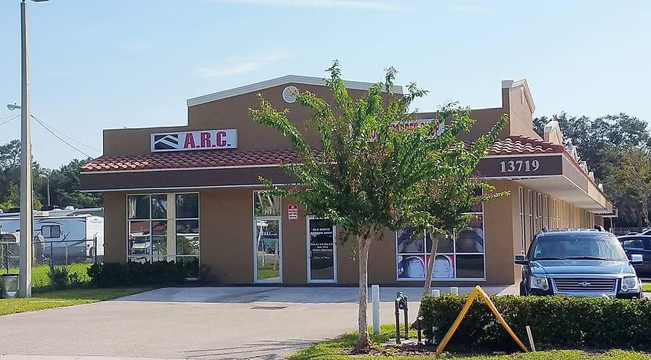 Red-roofed ARC building with flag and landscaped entrance