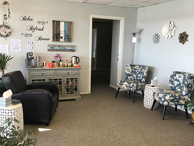 Cozy seating area with floral chairs and refreshment station