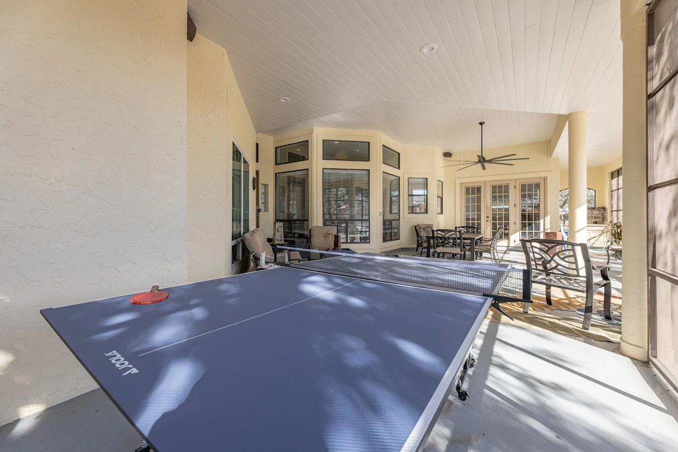Covered patio with ping pong table and outdoor seating