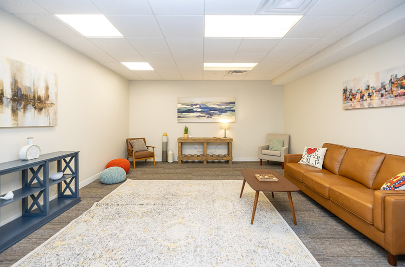 Spacious group lounge with couches and artwork