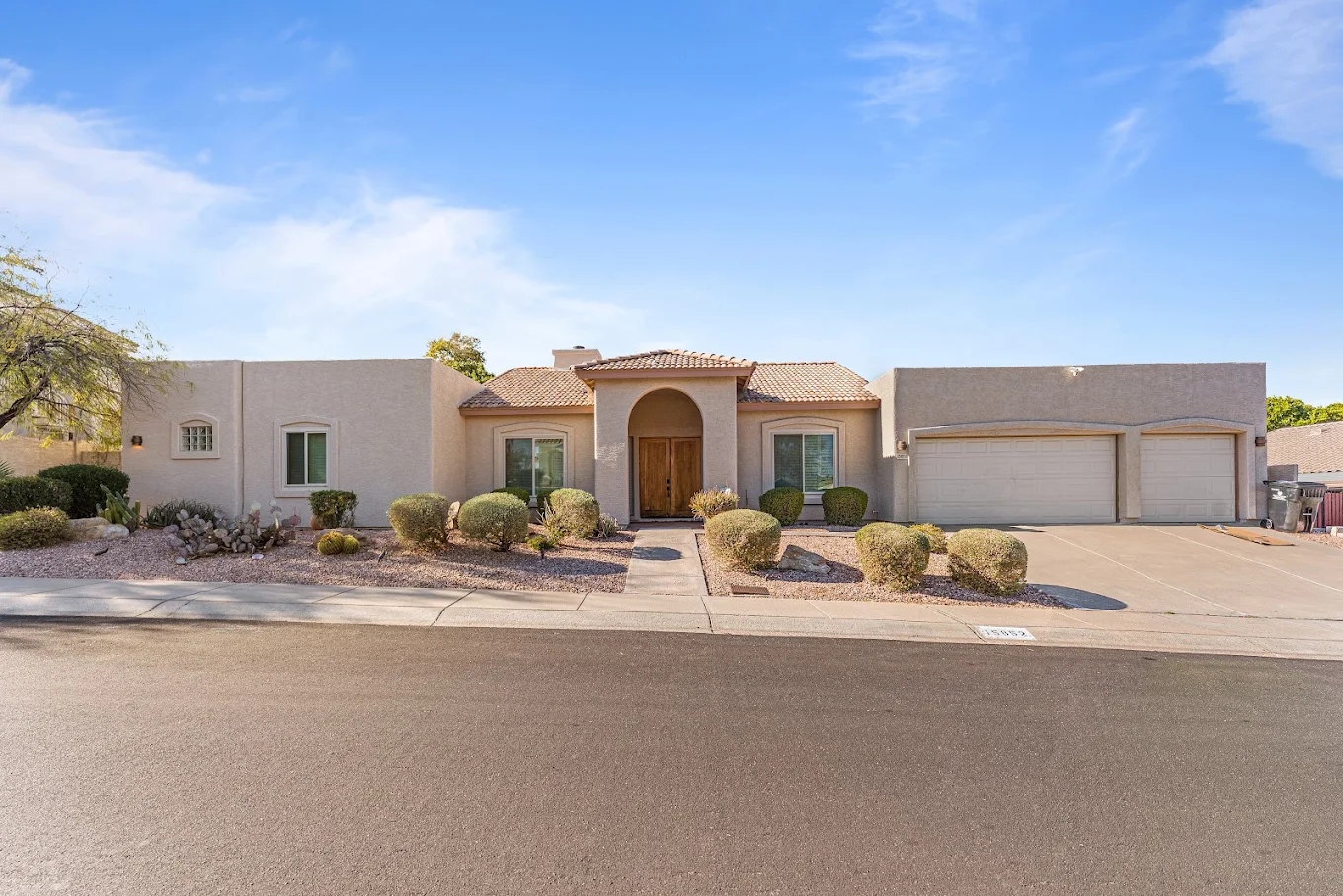 Residential facility exterior with landscaped front yard and garage.