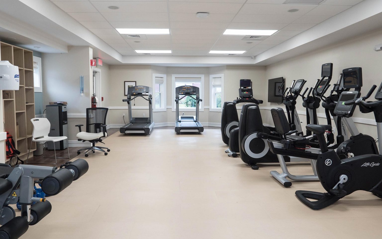 Gym with exercise machines and a TV.