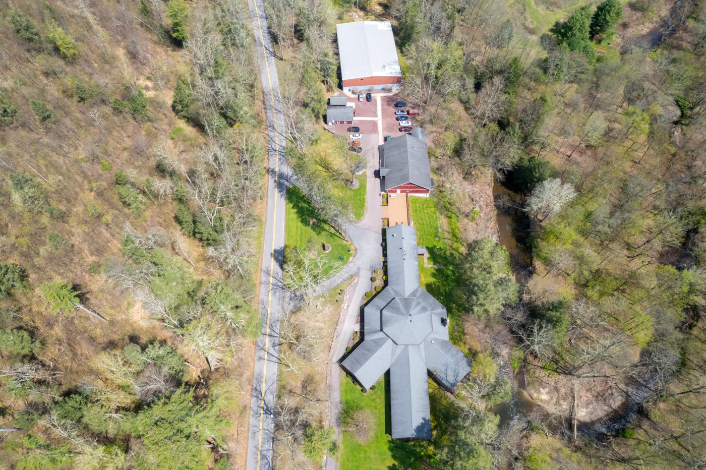 Aerial view of facility buildings and surrounding forest