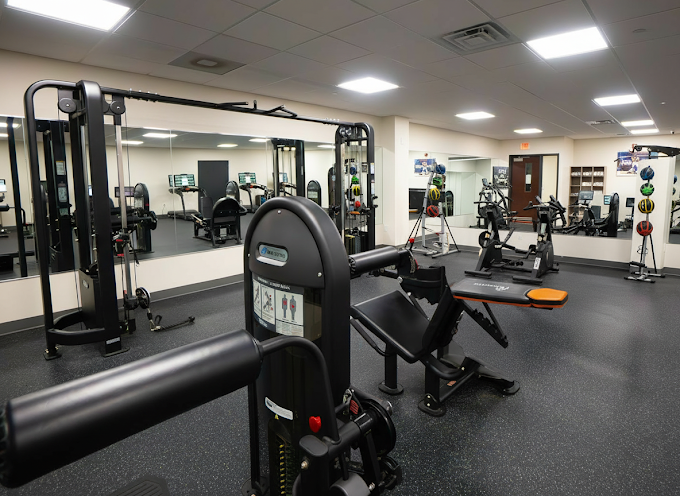 Fitness room with strength machines and mirrored walls