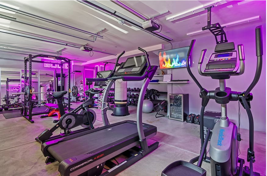 Fitness room with cardio machines and neon lights
