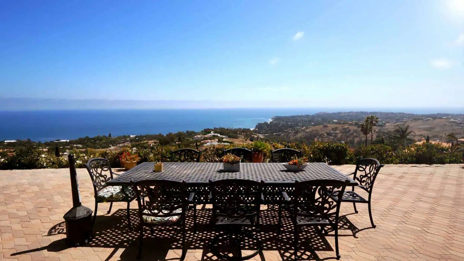 Outdoor patio with dining table overlooking the ocean